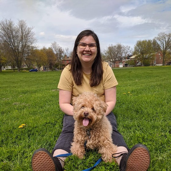 Melissa Mangos smiling in a park with her dog Finn